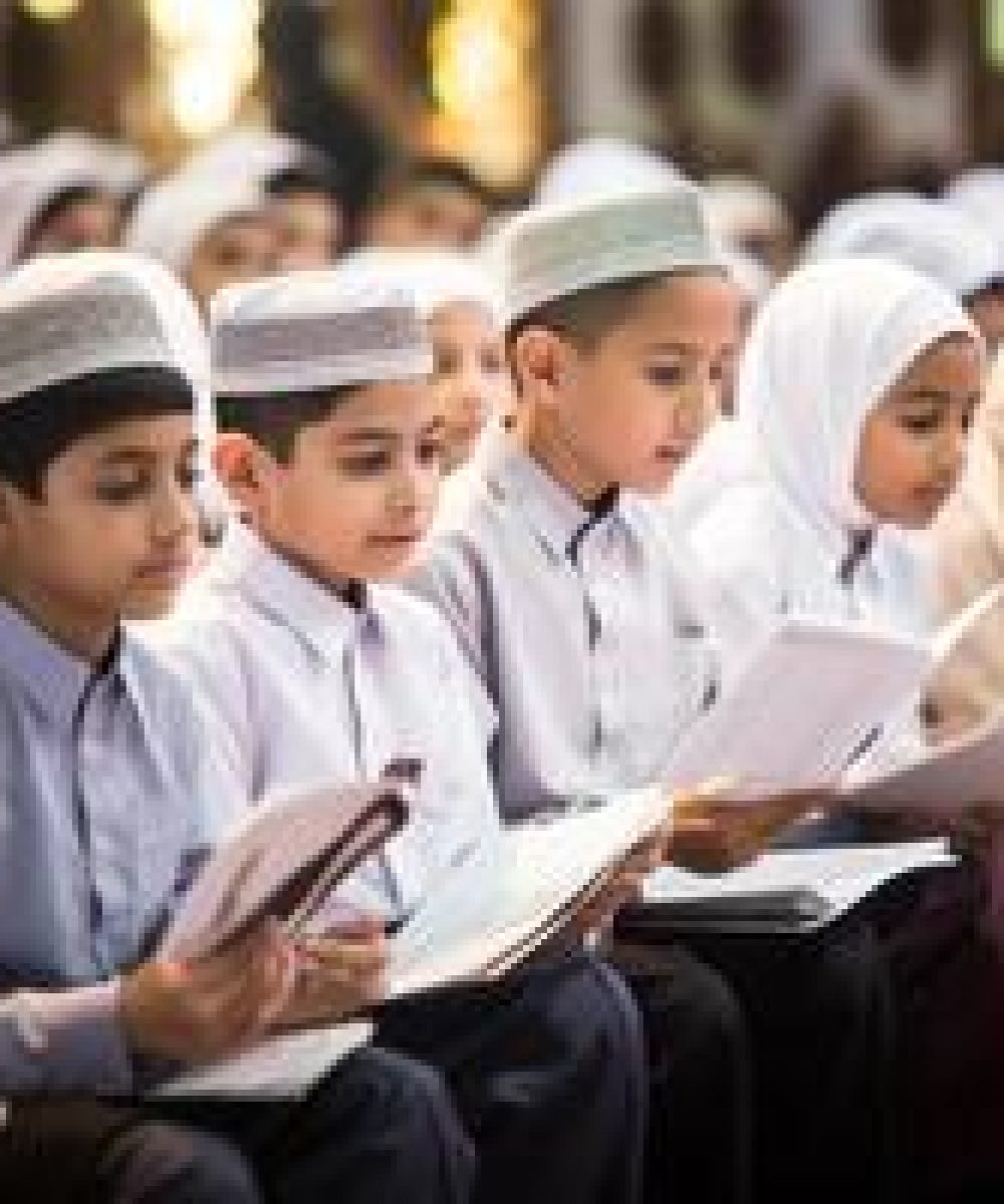 closeup-of-muslim-children-in-elegant-attire-reciting-the-quran-showcasing-their-devotion-and-cultural-heritage-generated-image-photo (1)